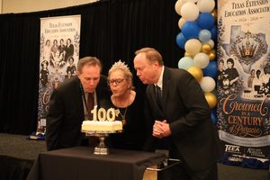 Blowing out 100 year anniversary cake